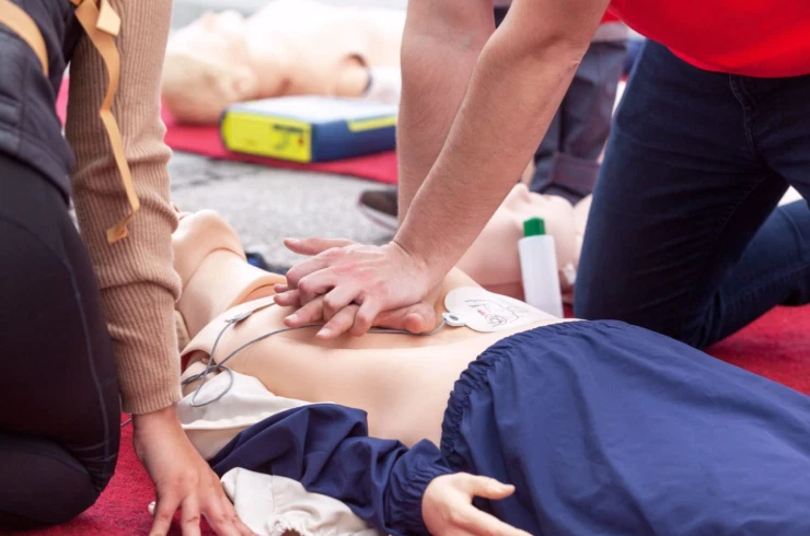 Hands-on CPR and AED practice on a training manikin during a Sun City West Foundation safety class.