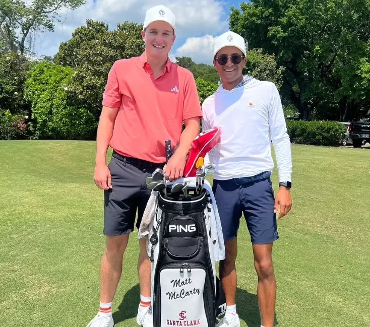 Two smiling golfers in caps and polos posing on the fairway with a black Ping golf bag labeled "Matt McCarty Santa Clara," backed by lush green trees.